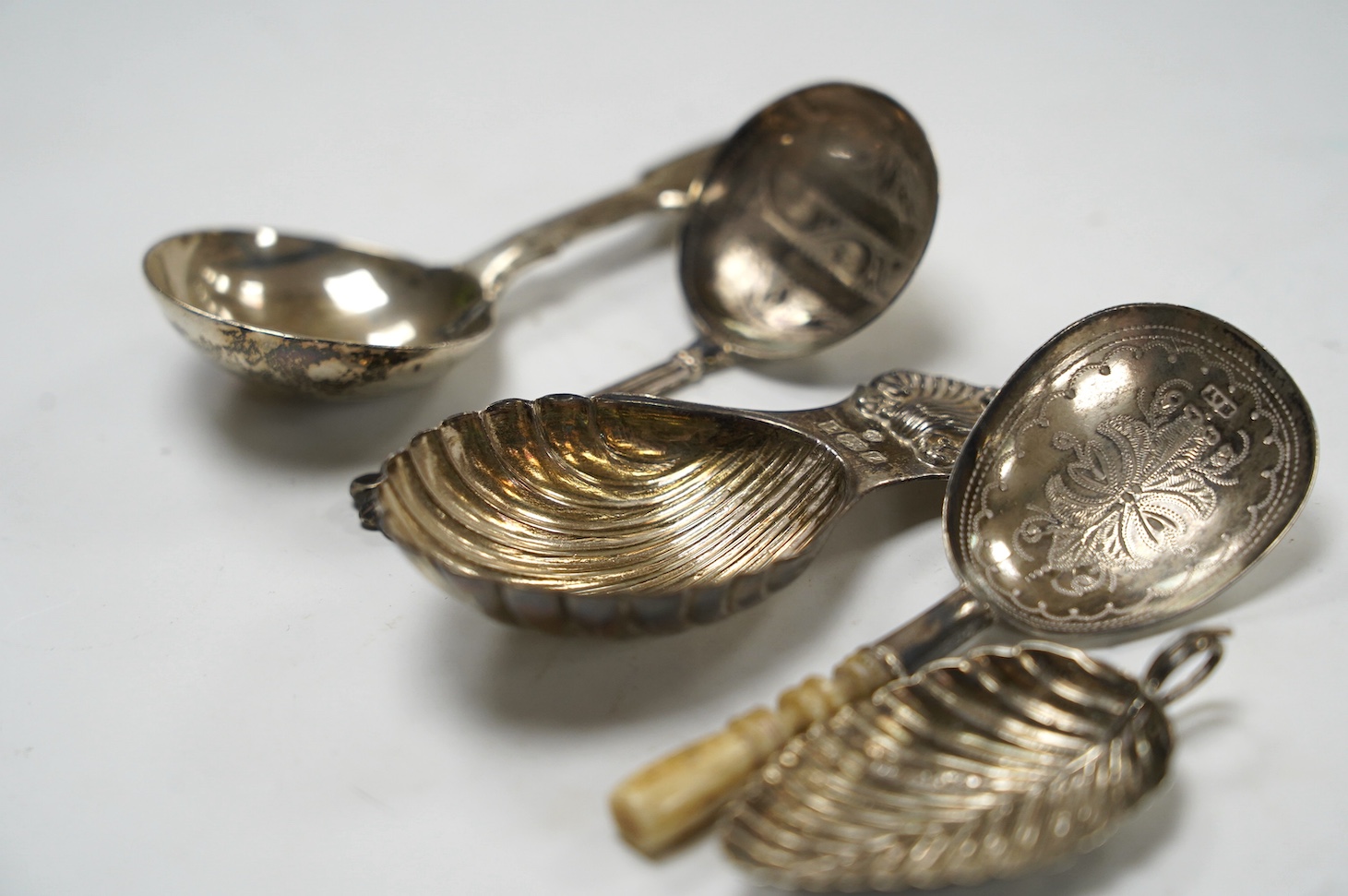 Five assorted silver caddy spoons, including fiddle pattern by Hayne & Cater, London, 1843, foliate terminal handled by George Unite, Birmingham, 1845, bone handled by Hilliard & Thomason, Birmingham, 1879, modern shell